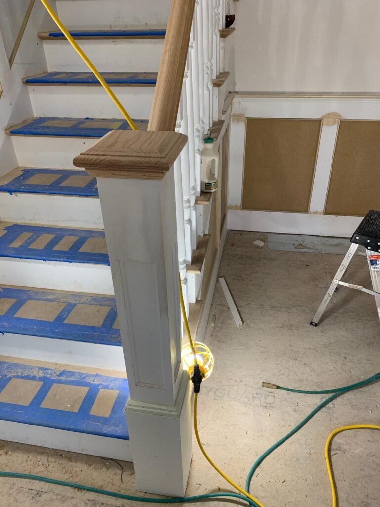 Staircase newel post and wainscoting by WHB Construction Corp.