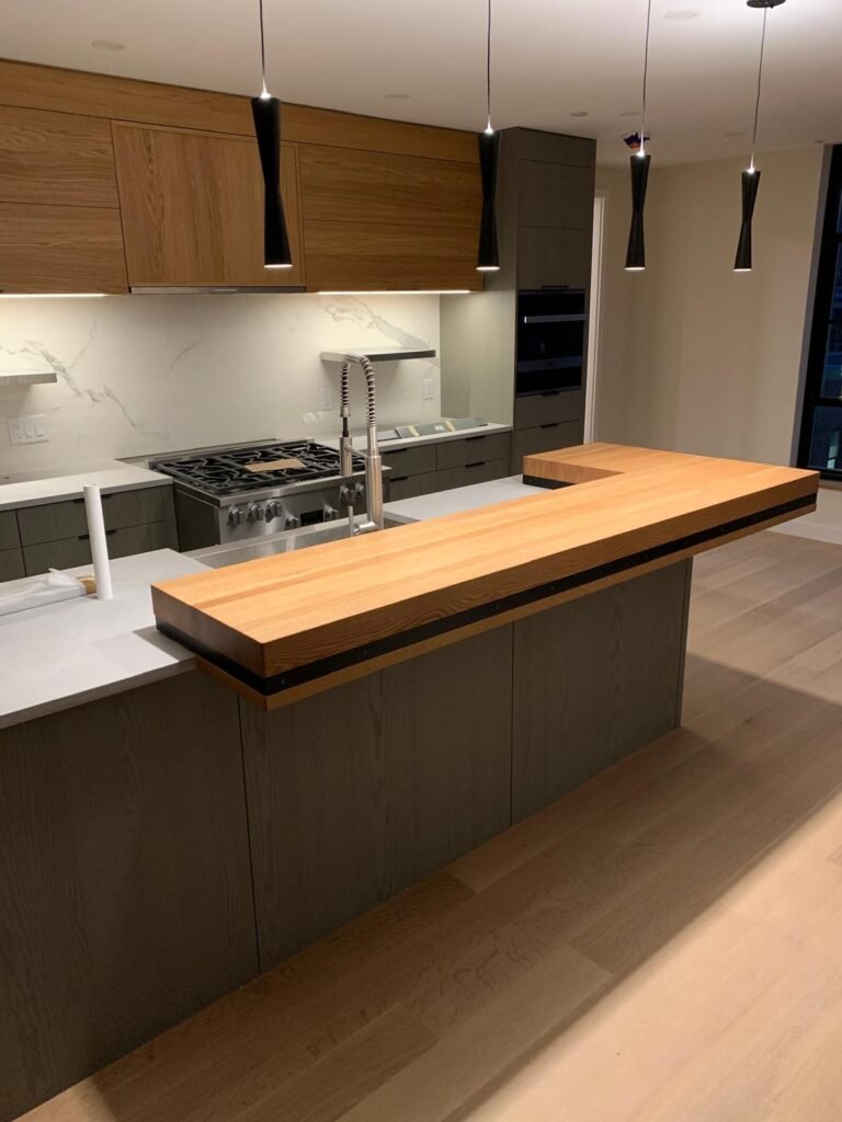Kitchen cabinet installation with island and butcher block countertop by WHB Construction Corp.